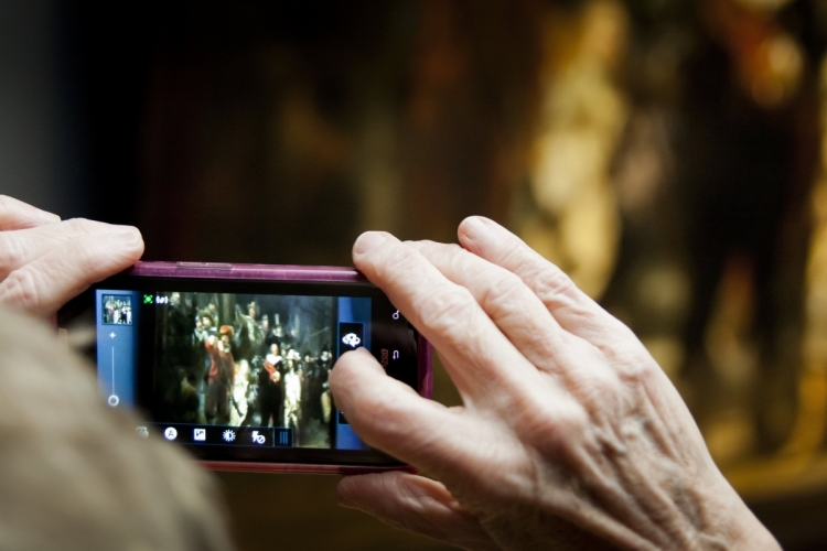 René den Engelsman, Bezoeker fotografeert de Nachtwacht met een digitale camera, 2013. Publiek domein via Rijksstudio.